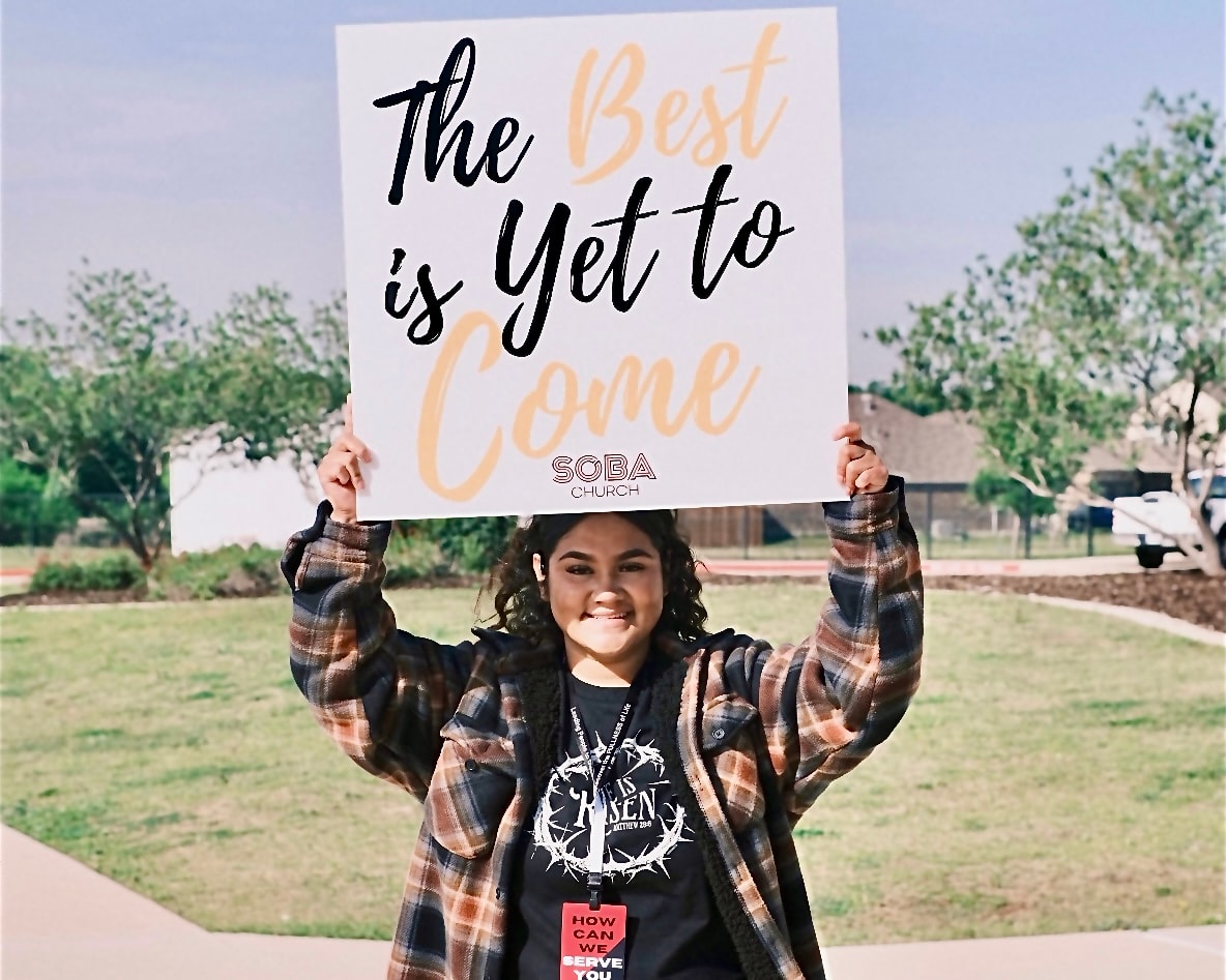 Girl holding welcome sign