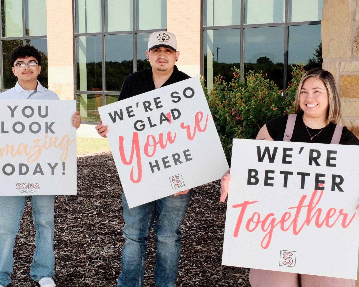 People holding welcome signs